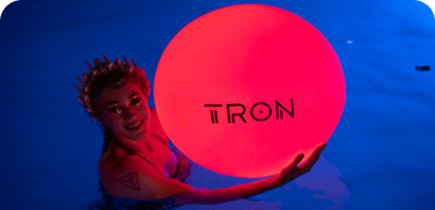 woman holding a red ball with tron logo